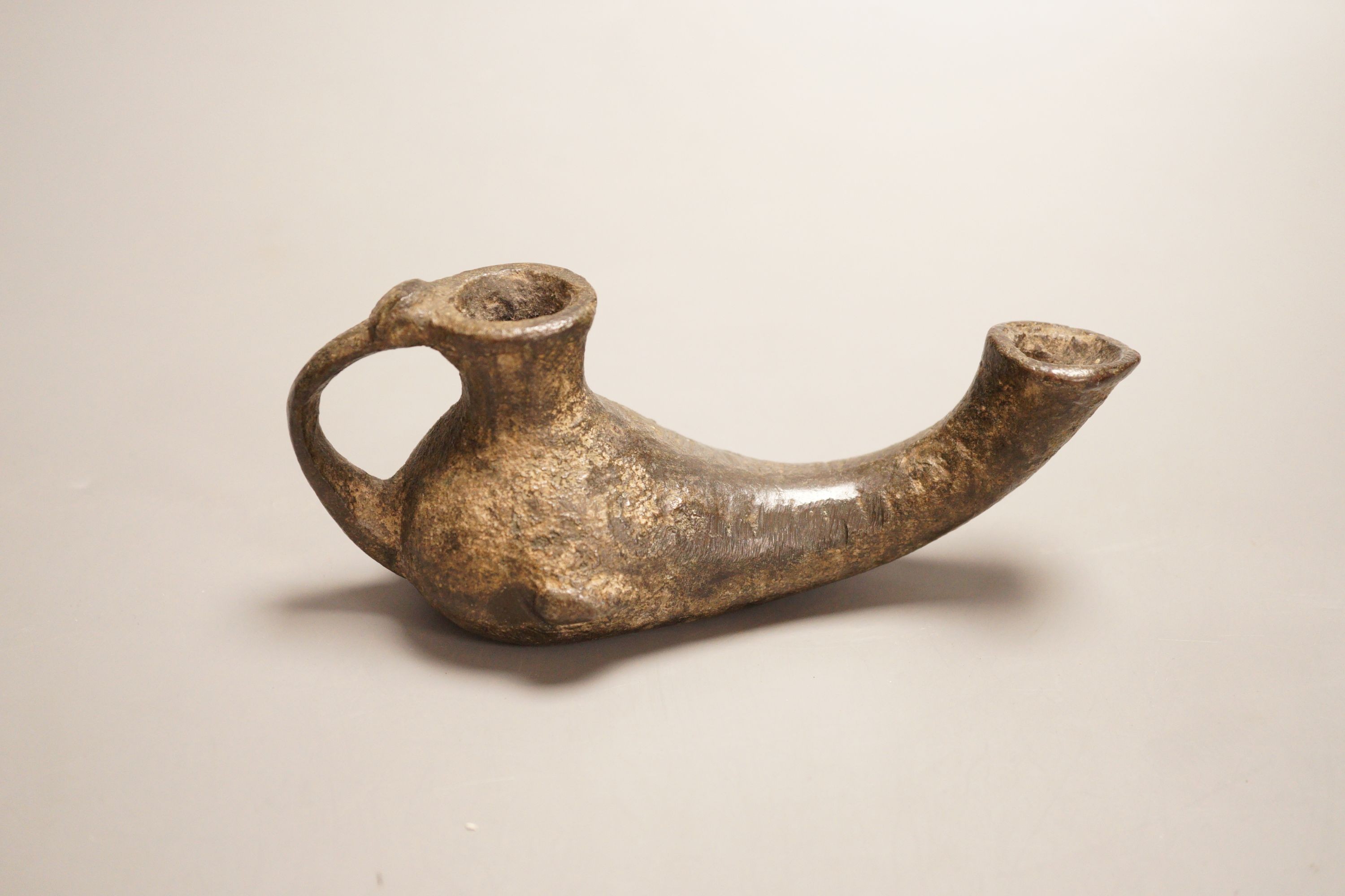 An early bronze oil lamp, probably Byzantine, 16cm long
